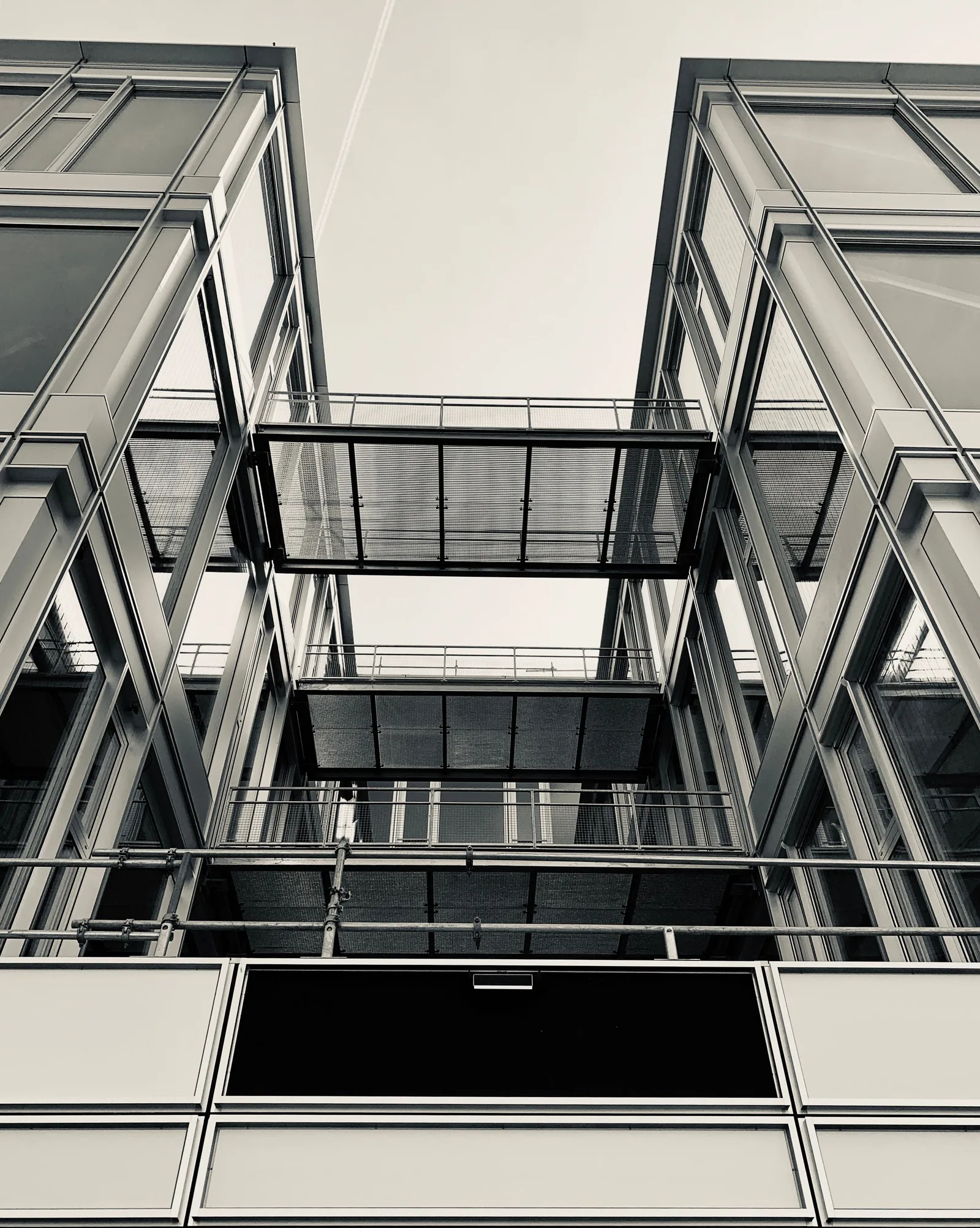 A steel and glass office facade seen from below