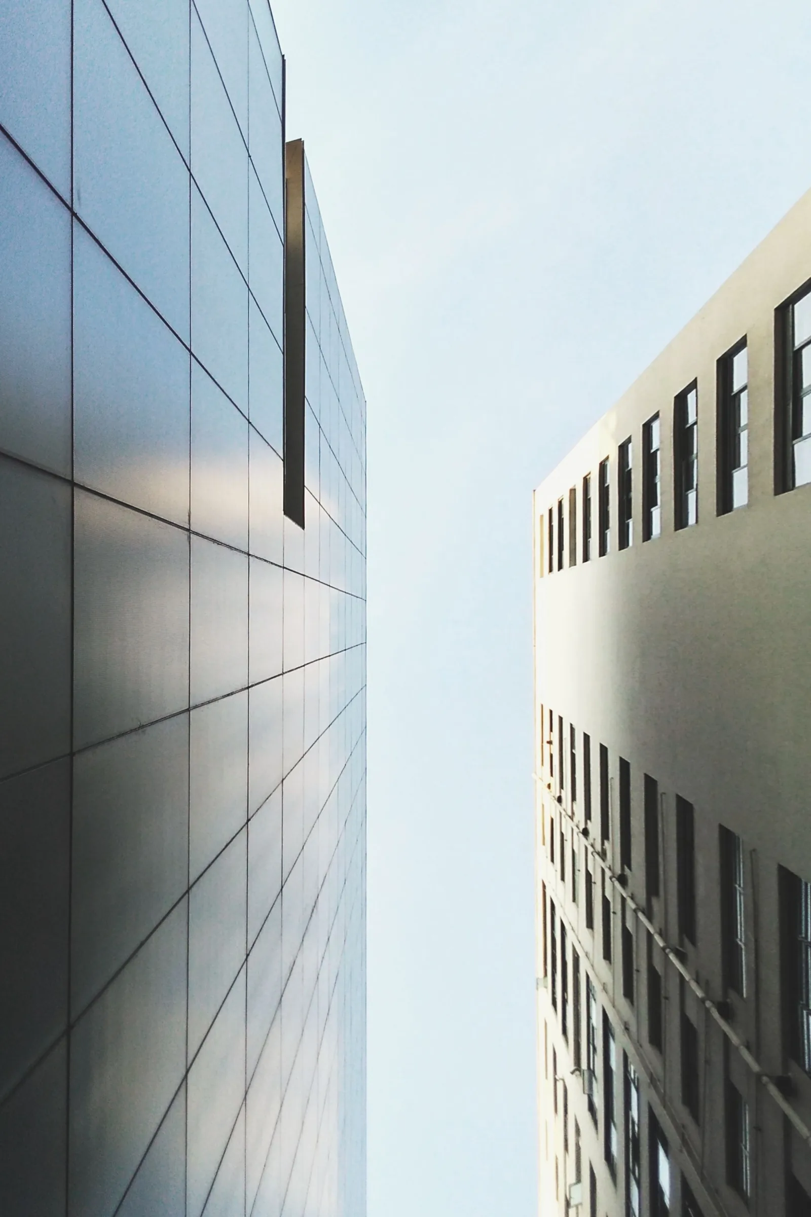 A tall office building against a pale sky